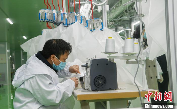 工人生產(chǎn)防護(hù)服，保障抗疫物資供應(yīng)。廣安市委宣傳部供圖