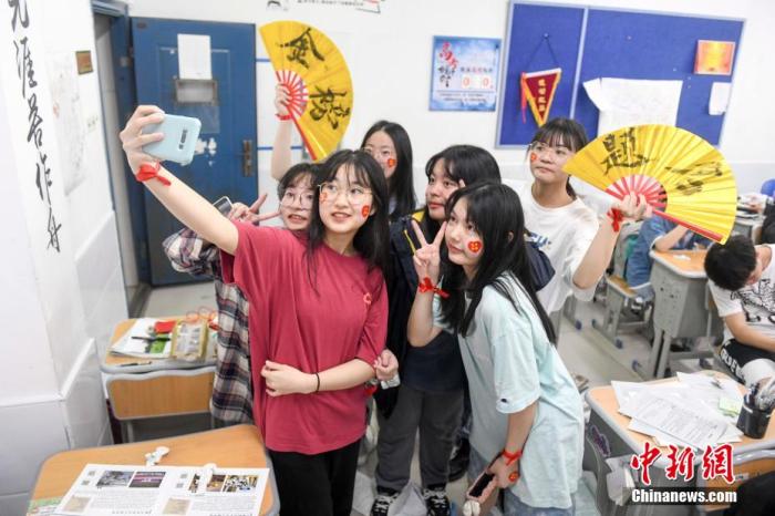 資料圖：6月6日，2021年高考前夕，湖南長沙同升湖實(shí)驗(yàn)學(xué)校高三年級，考生們在教室內(nèi)合影。 楊華峰 攝